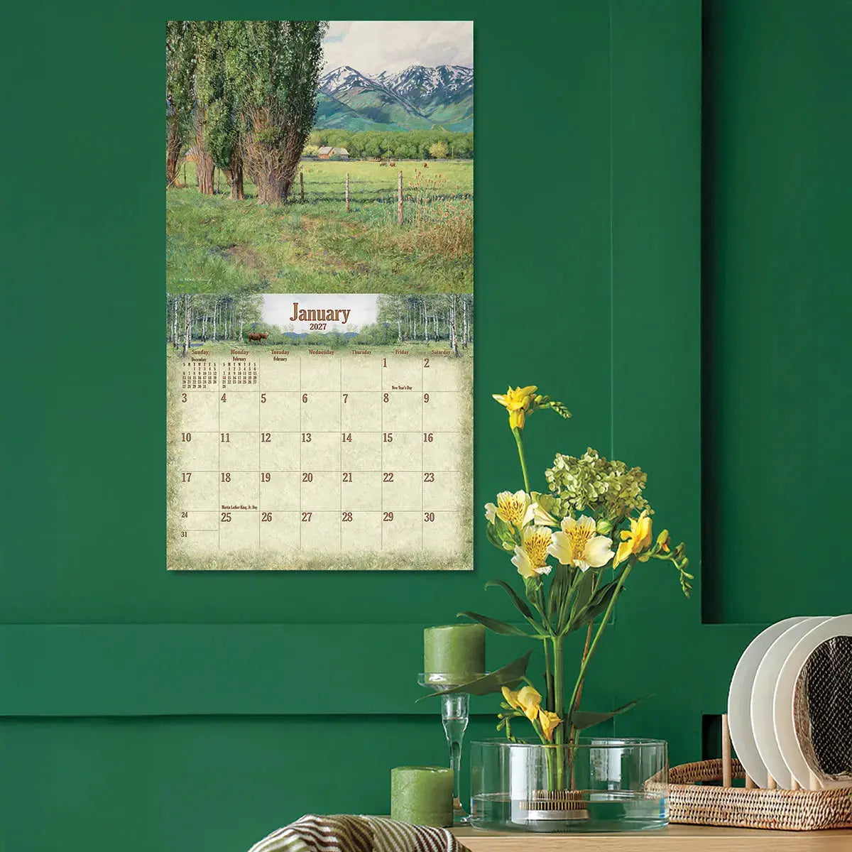 2027 Woodland Deluxe Wall Calendar by Ned Young - Open calendar on a green wall